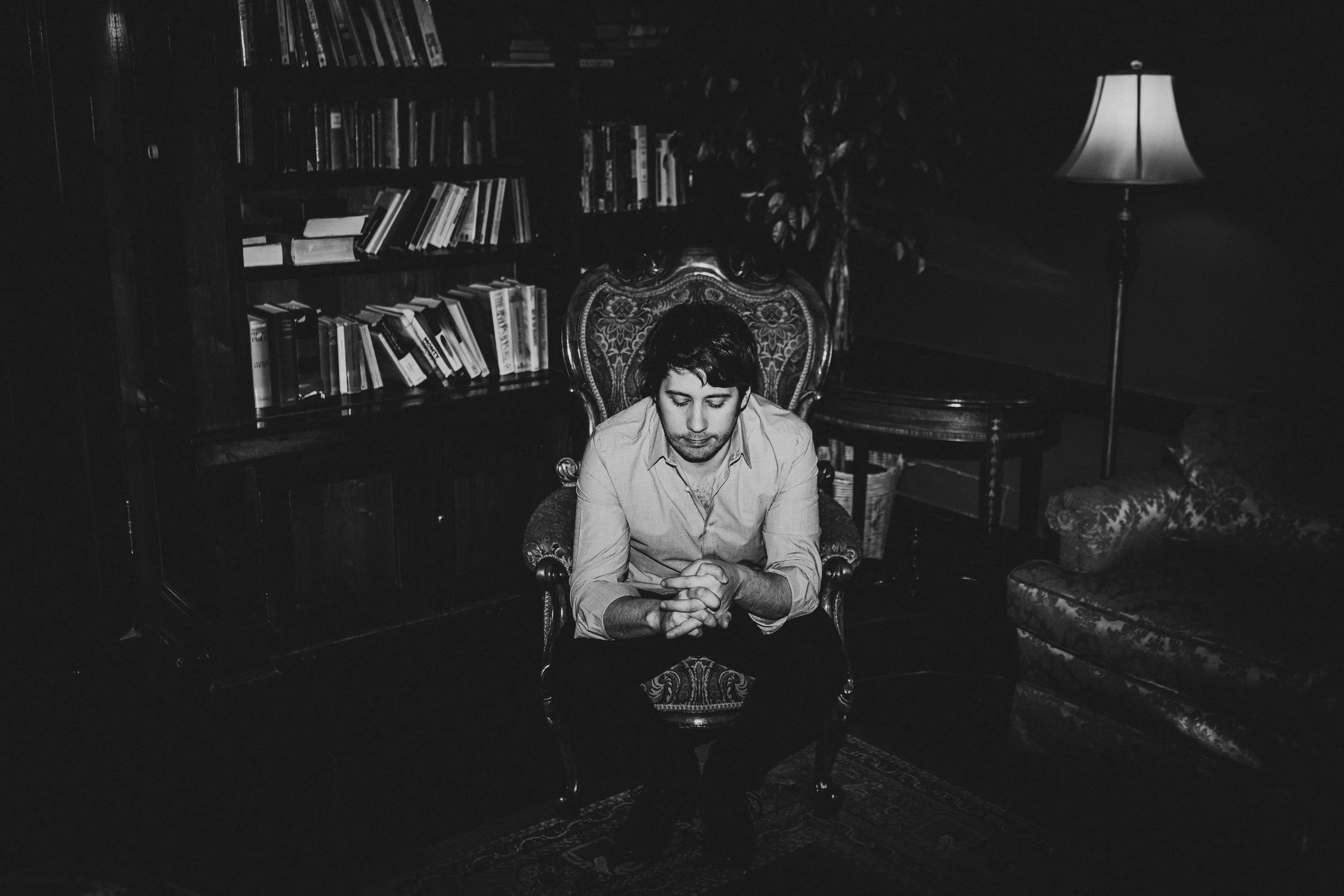 Matt Schellenberg, seated in a library